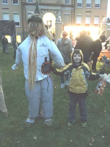 Kemper Phillips is seen with his scarecrow that won the prize for the
